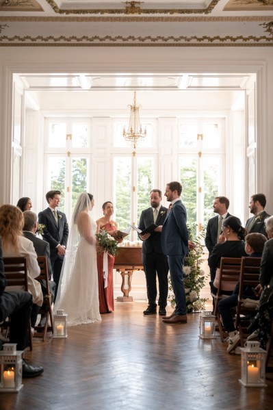 Bride groom guests seated and celebrant at alter during ceremony